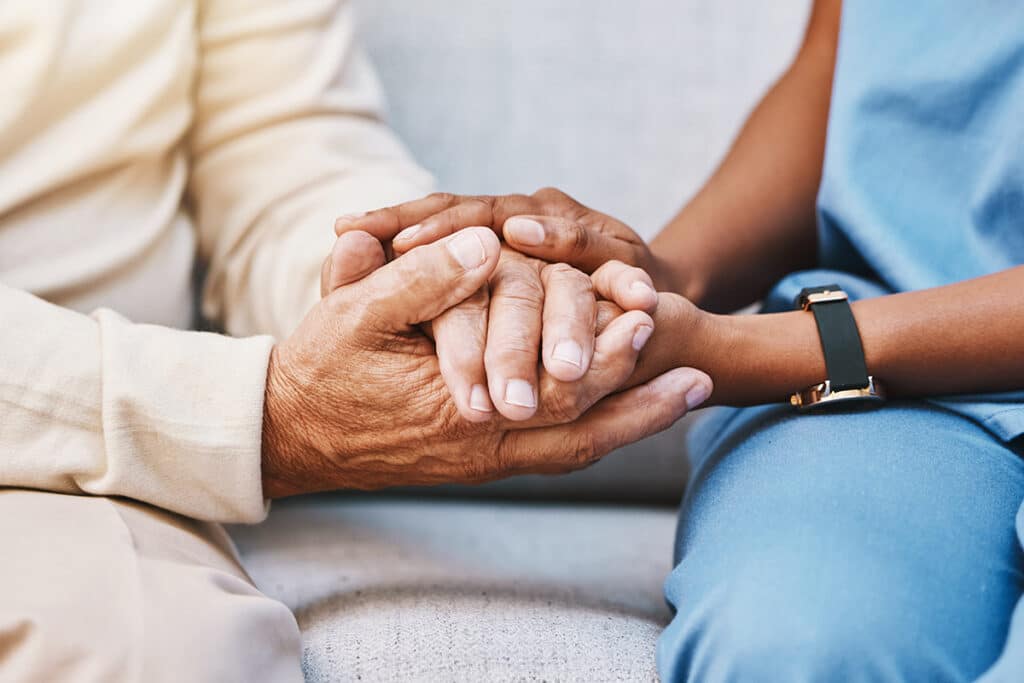 Nurse hands and senior patient in support