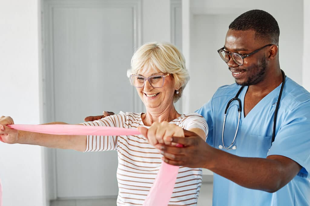 physical therapist and woman with band